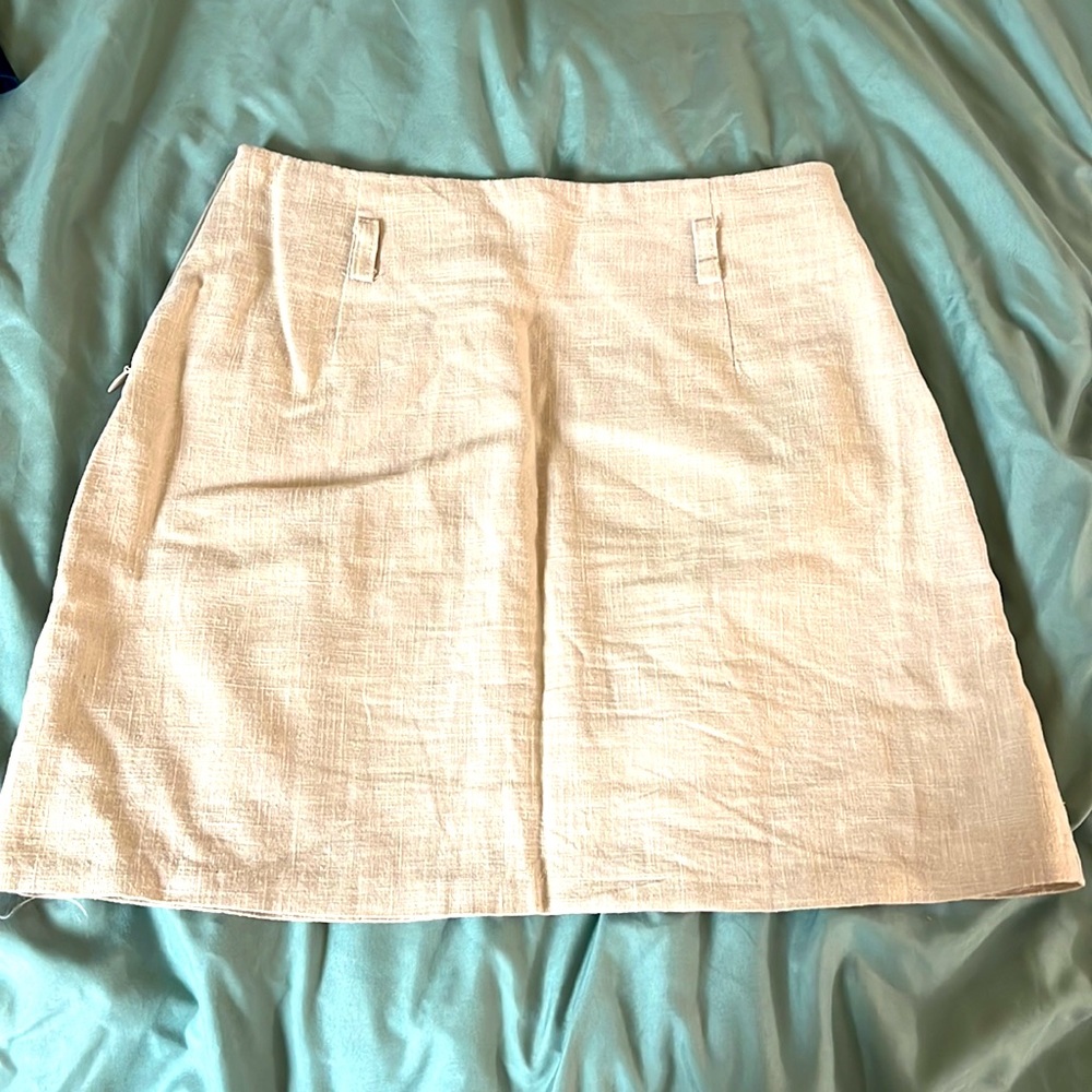 Made in Korea. Size small. Beige skirt with a side zip and belt loop